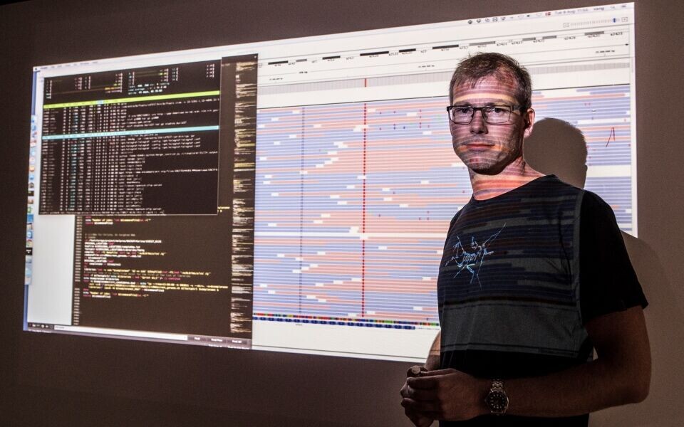 Det tager år for bioinformatikerne af udvikle serien af programmer til håndtering af data, også kaldet pipelinen. Bioinformatiker Søren Vang viser et eksempel. Den lange røde linje ned over skærmen afmærker en potentiel genfejl. Foto: Helle Arensbak