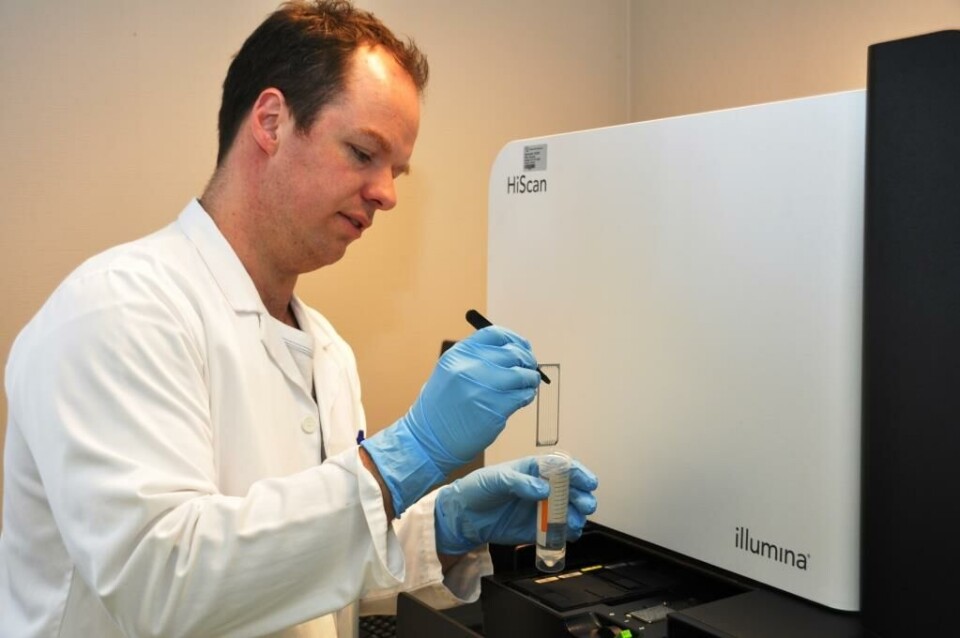 Det hender at Øyvind Busk kjører HTS-maskinen. Her holder han flowcellen som instrumentet leser av. På flowcellen hybridiseres prøve-DNA, og DNA-sekvensen blir avlest som én av fire farger. Fargekartene blir senere omgjort til DNA-sekvenser. Foto: Grete Hansen