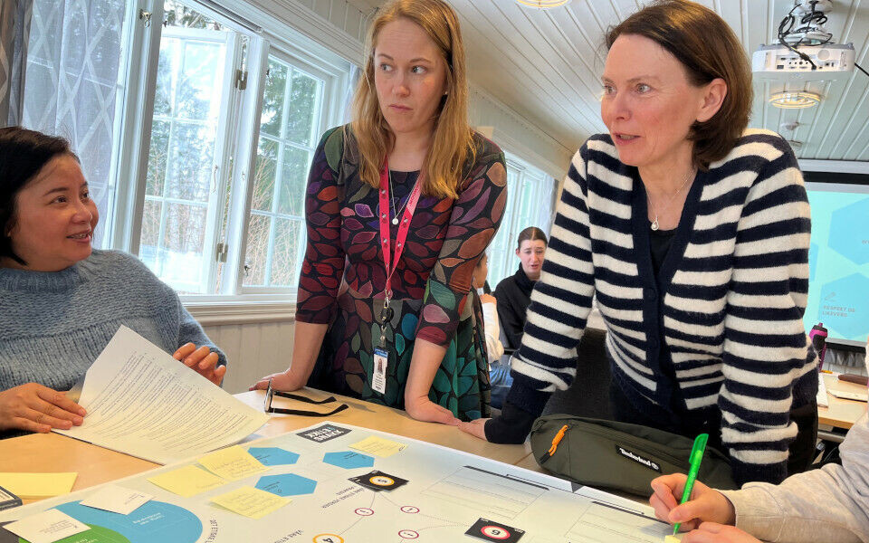Anita Thornquist (i midten) forteller at det var de ansatte på medisinsk biokjemi som selv ønsket en fagdag om etikk. BFIs Margrete Tennfjord (til høyre) ga deltakerne råd under etikkspillet og loste dem igjennom. «Spiller» Linh Ngoc lytter. Foto: Grete Hansen