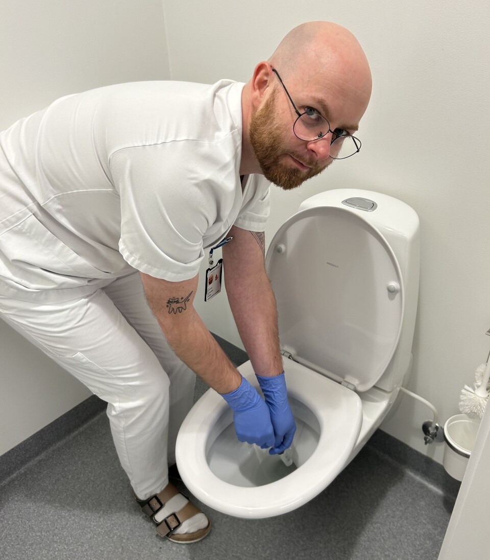 Smittevernsykepleier Ole F. Hansen tar vannprøve fra toalett.