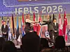 Deltakere med nasjonalflagg på en scene under IFRS 2026 foran publikum.